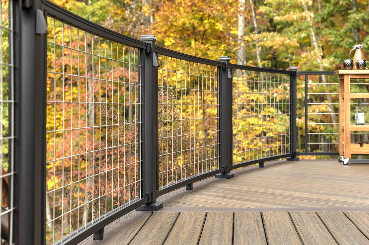 A Trex Signature Mesh railing with an autumn background.